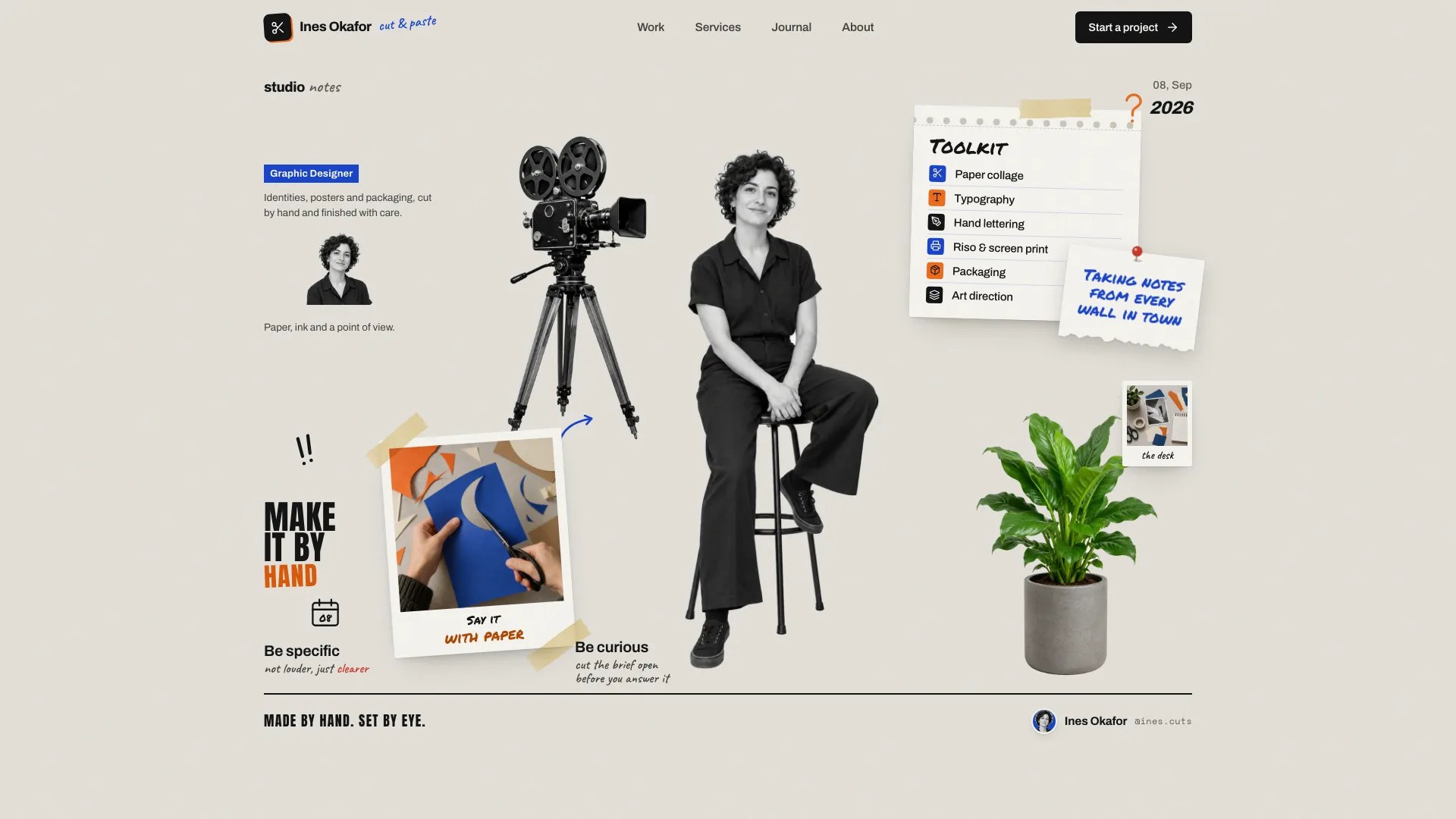 Ines Okafor studio-wall home page with a black-and-white cut-out portrait on a stool, a film camera, a taped toolkit notepad, a pinned note, an instant photo of hands cutting paper and the motto Make it by hand